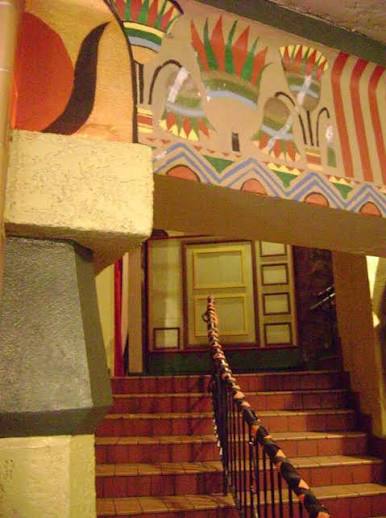 Painted Egyptian Revival motifs above an interior staircase at the Egyptian Theatre.